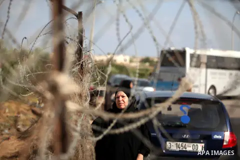 Palestinians wait for travel permits to cross into Egypt at the Rafah border crossing between Egypt and southern Gaza Strip June 23, 2015. Egyptian authorities last week decided to open the Rafah crossing to allow Palest...