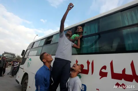 Palestinians wait for travel permits to cross into Egypt at the Rafah border crossing between Egypt and southern Gaza Strip June 23, 2015. Egyptian authorities last week decided to open the Rafah crossing to allow Palest...