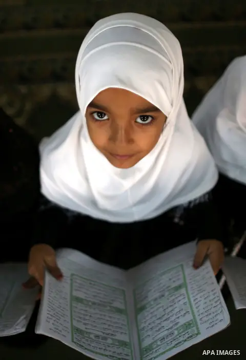 A Palestinian girl reads Quran in during the Muslim holy month of Ramadan, in a mosque in Balata refugee camp near the West Bank city of Nablus, June 23, 2015. Most Muslims around the world have begun observing the holy...