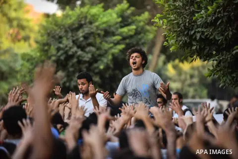 Members of Ultras Nahdawy group, who are supporters of the Muslim Brotherhood and ousted President Mohamed Morsi, light flares and shout slogans during a demonstration against military rule in Cairo, on June 23, 2015. Ph...
