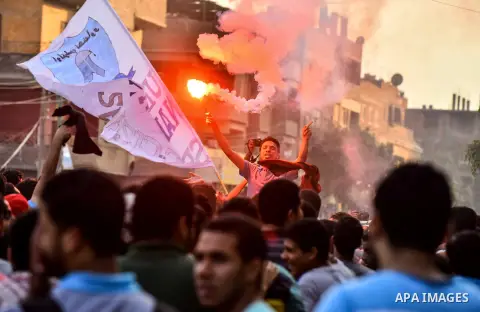 Members of Ultras Nahdawy group, who are supporters of the Muslim Brotherhood and ousted President Mohamed Morsi, light flares and shout slogans during a demonstration against military rule in Cairo, on June 23, 2015. Ph...