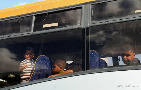 Palestinians wait for travel permits to cross into Egypt at the Rafah border crossing between Egypt and southern Gaza Strip June 24, 2015. Egyptian authorities last week decided to open the Rafah crossing to allow Palest...