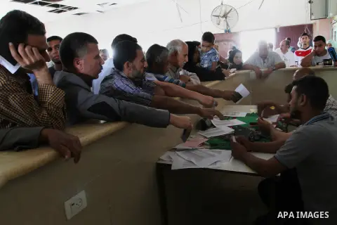 Palestinians wait for travel permits to cross into Egypt at the Rafah border crossing between Egypt and southern Gaza Strip June 24, 2015. Egyptian authorities last week decided to open the Rafah crossing to allow Palest...