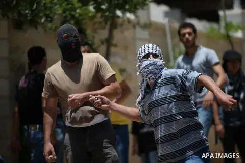 Palestinian protesters throw stones at Israeli security forces during clashes following a demonstration against the expropriation of Palestinian land by Israel in the West Bank village of Kfar Qaddum, near Nablus, on Jun...