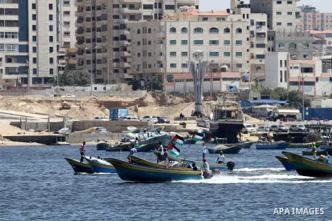 Palestinians riding boats hold Palestinian flags during a protest against the Israeli blocking of a boat of foreign activists from reaching Gaza, at the Seaport of Gaza City June 29, 2015. Israel said on Monday it had bl...