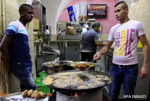 A Palestinian man sells falafel at his shop on the holy month of Ramadan, in Jerusalem's old city on June 29, 2015. During Ramadan, Muslim believers abstain from eating, drinking, smoking and having sex from dawn until s...