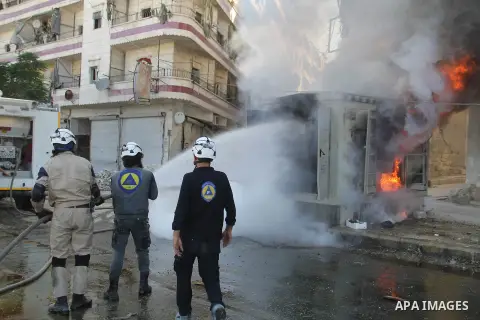 Syrian firefighters try to extinguish the fire in the burning houses in a reported barrel bomb attack by Syrian government forces in Bab al-Nairab district in the northern Syrian city of Aleppo, on July 1, 2015. Photo by...