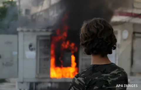 Syrian firefighters try to extinguish the fire in the burning houses in a reported barrel bomb attack by Syrian government forces in Bab al-Nairab district in the northern Syrian city of Aleppo, on July 1, 2015. Photo by...