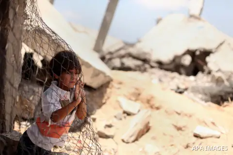 Palestinian childern play on the ruins of houses, that witnesses said were destroyed by Israeli shelling during a 50-day war last summer, in Khan Younis in the southern Gaza Strip July 2, 2015. Robert Turner has no quick...
