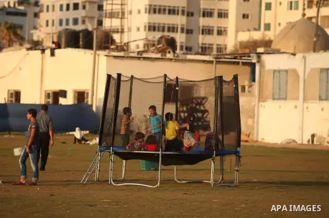 Palestinian children play at the Gaza seaport, on July 06, 2015. Photo by Ashraf Amra