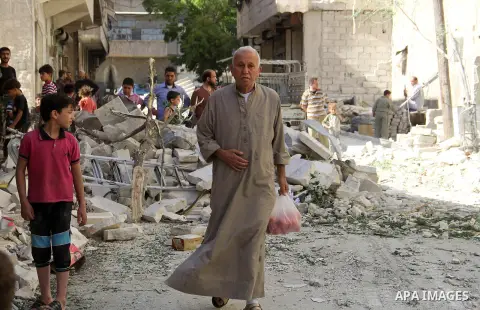 Syrians inspect the damage following a reported bomb barrel attack by Syrian government forces hit al-Mayser rebel held neighborhood in the northern Syrian city of Aleppo, July 6, 2015. Photo by Ameer al-Halbi