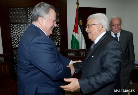 Palestinian President Mahmoud Abbas meets with Greek Foreign Minister Nikos Kotzias, in the West Bank city of Ramallah on July 7, 2015. Photo by Thaer Ganaim