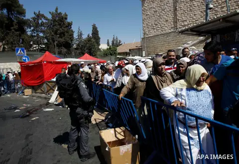 Israeli security officer stands guard as Palestinian Muslim worshipers try to enter the al-Aqsa mosque compound to attend the fourth Friday prayers of the muslim's fasting month of Ramadan, in Jerusalem's old city on Jul...