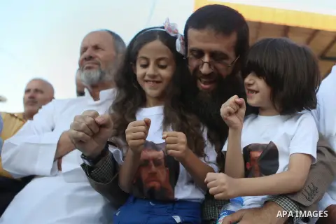 Palestinian Islamic Jihad leader Khader Adnan celebrates with his sons during a rally honoring him following his release, near the West Bank city of Jenin July 12, 2015. Israel on Sunday released Adnan from jail followin...