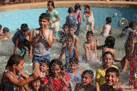 Palestinian children enjoy swimming in a pool at an amusement park on the third day of Eid al-Fitr holiday which marks the end of the Muslim holy month of Ramadan, in Gaza City on July 19, 2015. Photo by Ashraf Amra