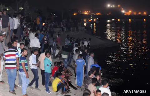 Egyptians gather at the site of a shipwreck on the Nile River in the Warraq district of Giza, southwest of Cairo, Egypt, on July 23, 2015. At least 19 people died Wednesday in a shipwreck on Nile River in Cairo, capital...