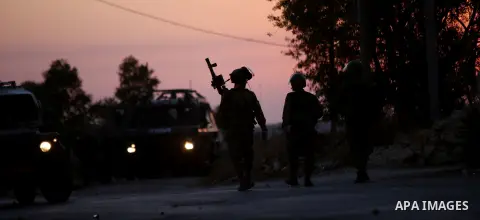 Israeli soldiers take position during clashes with Palestinian protesters following a protest against the construction of settlements and the confiscation of the Palestinian land, in the West Bank village of Silwad, near...