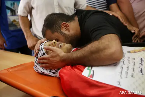Relatives of Palestinian Mohammed Abu Latifa, 19, mourn during his funeral in Qalandiya refugee camp, near the West Bank city of Ramallah July 27, 2015. Abu Latifa, wanted on suspicion of planning a militant attack, fell...