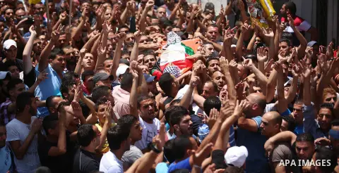 Mourners carry the body of Palestinian Mohammed Abu Latifa, 19, during his funeral in Qalandiya refugee camp, near the West Bank city of Ramallah July 27, 2015. Abu Latifa wanted on suspicion of planning a militant attac...