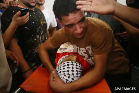 Relatives of Palestinian Mohammed Abu Latifa, 19, mourn during his funeral in Qalandiya refugee camp, near the West Bank city of Ramallah July 27, 2015. Abu Latifa, wanted on suspicion of planning a militant attack, fell...