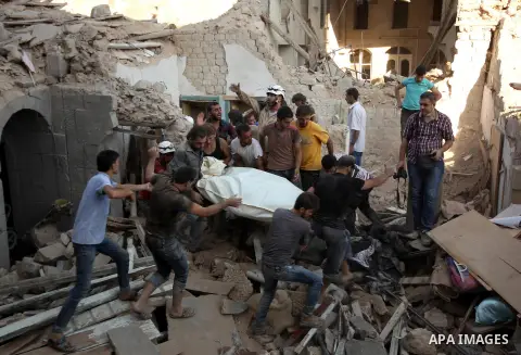 Syrians search for survivors amidst the rubble of a house after a reported missile fired by Syrian government forces hit a residential area in the Jeb Al-Qubbah district in the northern Syrian city of Aleppo on July 27,...