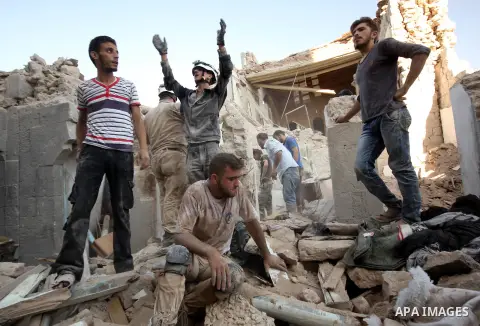 Syrians search for survivors amidst the rubble of a house after a reported missile fired by Syrian government forces hit a residential area in the Jeb Al-Qubbah district in the northern Syrian city of Aleppo on July 27,...
