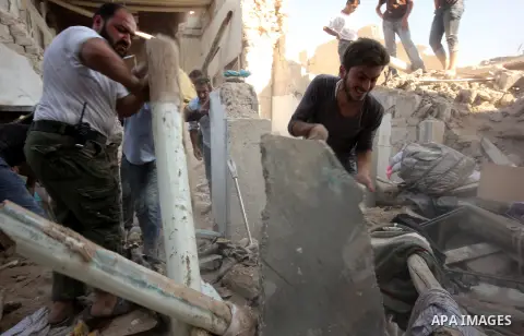 Syrians search for survivors amidst the rubble of a house after a reported missile fired by Syrian government forces hit a residential area in the Jeb Al-Qubbah district in the northern Syrian city of Aleppo on July 27,...
