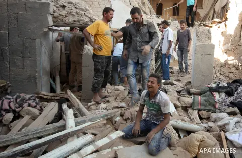 A Syrian man cries as he sits on the rubble of a house after a reported missile fired by Syrian government forces hit a residential area in the Jeb Al-Qubbah district in the northern Syrian city of Aleppo on July 27, 201...