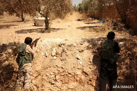 Fighters from the Free Syrian Army take position following clashes with the pro-regime forces, in Aziza village in the northern Syrian city of Aleppo, on July 28, 2015. Photo by Ameer al-Halbi
