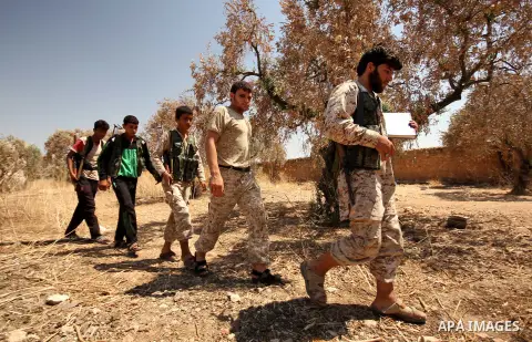 Fighters from the Free Syrian Army patrol the area following clashes with the pro-regime forces, in Aziza village in the northern Syrian city of Aleppo, on July 28, 2015. Photo by Ameer al-Halbi