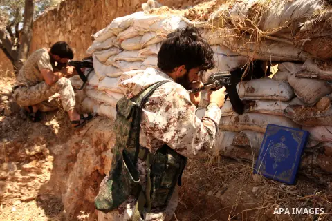 Fighters from the Free Syrian Army take position following clashes with the pro-regime forces, in Aziza village in the northern Syrian city of Aleppo, on July 28, 2015. Photo by Ameer al-Halbi