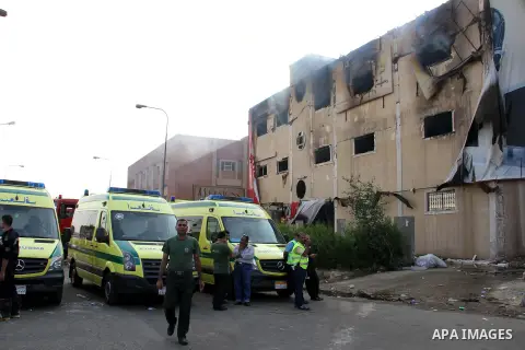 Egyptian police and ambulances are seen outside the Al-Helw furniture factory north of the capital Cairo after the building caught on fire killing at least 19 working according to security and health workers, on July 28,...