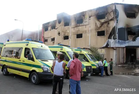 Egyptian police and ambulances are seen outside the Al-Helw furniture factory north of the capital Cairo after the building caught on fire killing at least 19 working according to security and health workers, on July 28,...