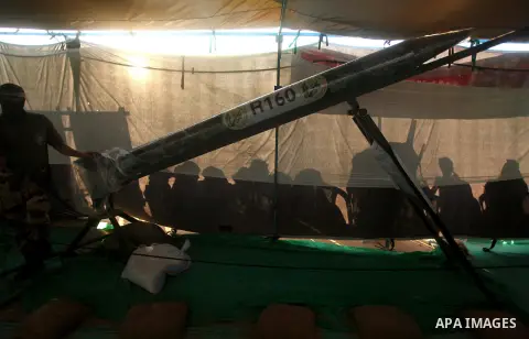 Palestinians watch weapons that used during the Israeli 50-day war on Gaza Strip last summer, during a weapons exhibition in a military-style camp organized by the Hamas movement in Gaza City on July 28, 2015. Hamas's ar...