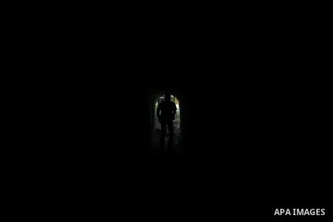 A Palestinian man walks in a military tunnel during a weapons exhibition in a military-style camp organized by the Hamas movement in Gaza City on July 28, 2015. Hamas's armed wing organized "Liberation Youths Camps" for...