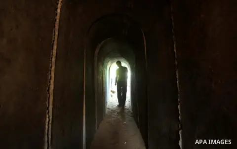 A Palestinian man walks in a military tunnel during a weapons exhibition in a military-style camp organized by the Hamas movement in Gaza City on July 28, 2015. Hamas's armed wing organized "Liberation Youths Camps" for...
