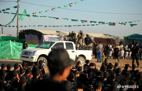Palestinian militants of Ezzeddin al-Qassam brigades demonstrate their skills during a military-style camp organized by the Hamas movement in Gaza City on July 28, 2015. Hamas's armed wing organized "Liberation Youths Ca...