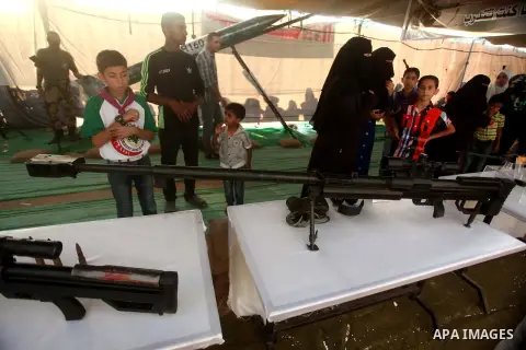 Palestinians watch weapons that used during the Israeli 50-day war on Gaza Strip last summer, during a weapons exhibition in a military-style camp organized by the Hamas movement in Gaza City on July 28, 2015. Hamas's ar...