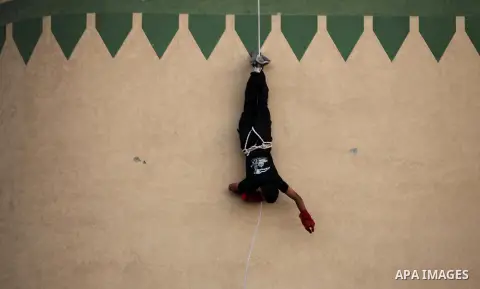 A Palestinian youth demonstrates his skills during a military-style camp organized by the Hamas movement in Gaza City on July 28, 2015. Hamas's armed wing organized "Liberation Youths Camps" for young Palestinians aged b...