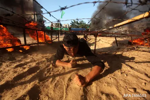 Palestinian youths demonstrate their skills during a military-style camp organized by the Hamas movement in Gaza City on July 28, 2015. Hamas's armed wing organized "Liberation Youths Camps" for young Palestinians aged b...