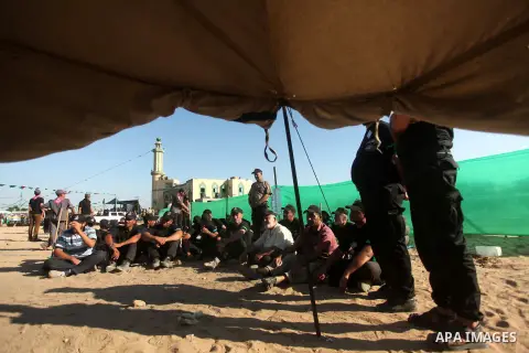 Palestinians take part in a military-style camp organized by the Hamas movement in Gaza City on July 28, 2015. Hamas's armed wing organized "Liberation Youths Camps" for young Palestinians aged between 15 and 21 to prepa...