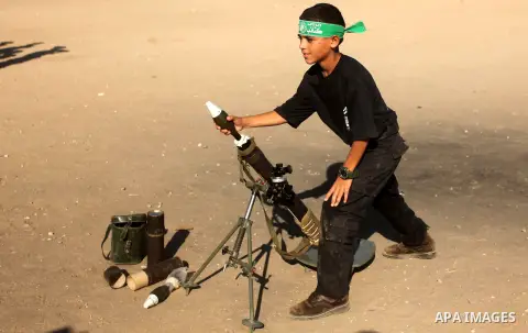 Palestinian youths take part in a military-style camp organized by the Hamas movement in Gaza City on July 28, 2015. Hamas's armed wing organized "Liberation Youths Camps" for young Palestinians aged between 15 and 21 to...