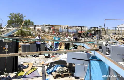 Palestinians search for their belongings after their businesses, consisting of a wedding hall and shop, were razed by the Israeli military in the Arab east Jerusalem neighbourhood of Beit Hanina on July 29, 2015. Accordi...