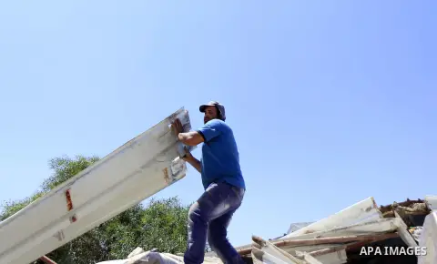 Palestinians search for their belongings after their businesses, consisting of a wedding hall and shop, were razed by the Israeli military in the Arab east Jerusalem neighbourhood of Beit Hanina on July 29, 2015. Accordi...