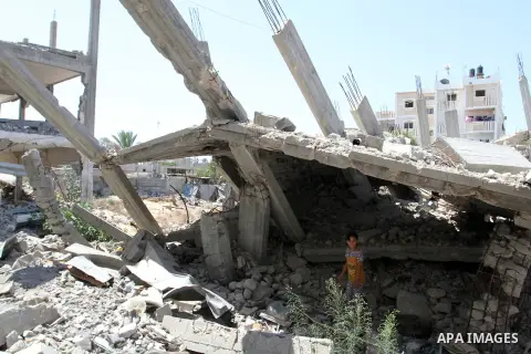 A Palestinian girl plays on the rubble of a house, which was destroyed during the 50-day war between Israel and Hamas militants in the summer of 2014, in Rafah in the southern Gaza Strip on July 29, 2015. An analysis of...