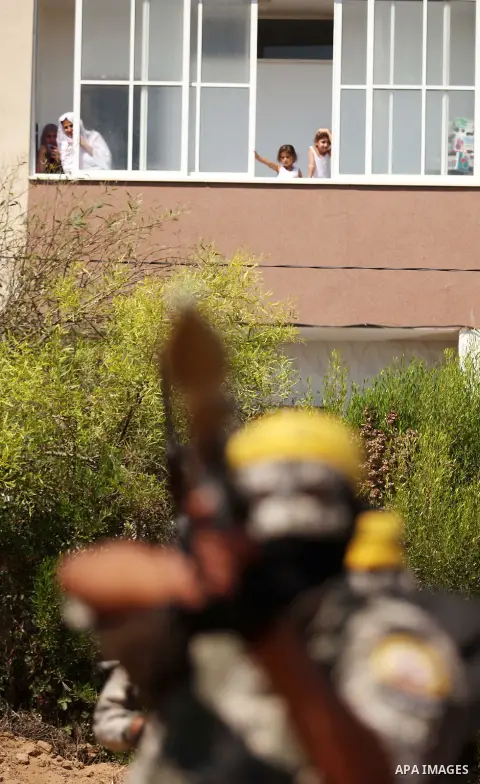 Palestinian militants of al-Aqsa brigades, the armed wing of Fatah movement, celebrate the release of prisoner Mahmoud Abu Amra from an Israeli jail, in Deir al-Balah in the central Gaza Strip, July 30, 2015. Abu Amra se...