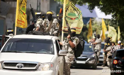 Palestinian militants of al-Aqsa brigades, the armed wing of Fatah movement, celebrate the release of prisoner Mahmoud Abu Amra from an Israeli jail, in Deir al-Balah in the central Gaza Strip, July 30, 2015. Abu Amra se...