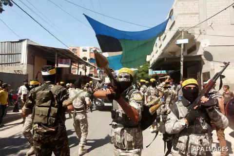 Palestinian militants of al-Aqsa brigades, the armed wing of Fatah movement, celebrate the release of prisoner Mahmoud Abu Amra from an Israeli jail, in Deir al-Balah in the central Gaza Strip, July 30, 2015. Abu Amra se...
