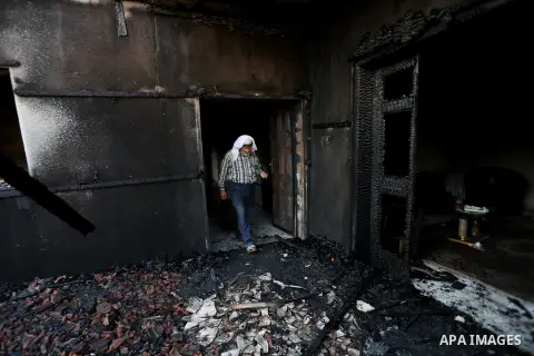 A Palestinian man inspects a house that was badly damaged from a suspected attack by Jewish extremists on two houses at Kafr Duma village near the West Bank city of Nablus July 31, 2015. The house had been empty and ther...