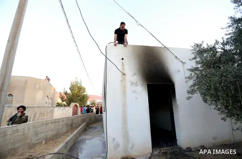 A Palestinian man inspects a house that was badly damaged from a suspected attack by Jewish extremists on two houses at Kafr Duma village near the West Bank city of Nablus July 31, 2015. The house had been empty and ther...
